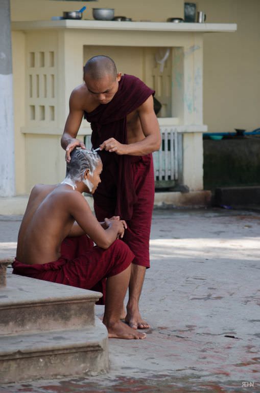 A monk having a shave