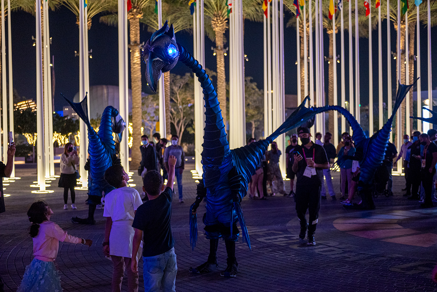 Costumed bird characters interaction with kids in the plaza