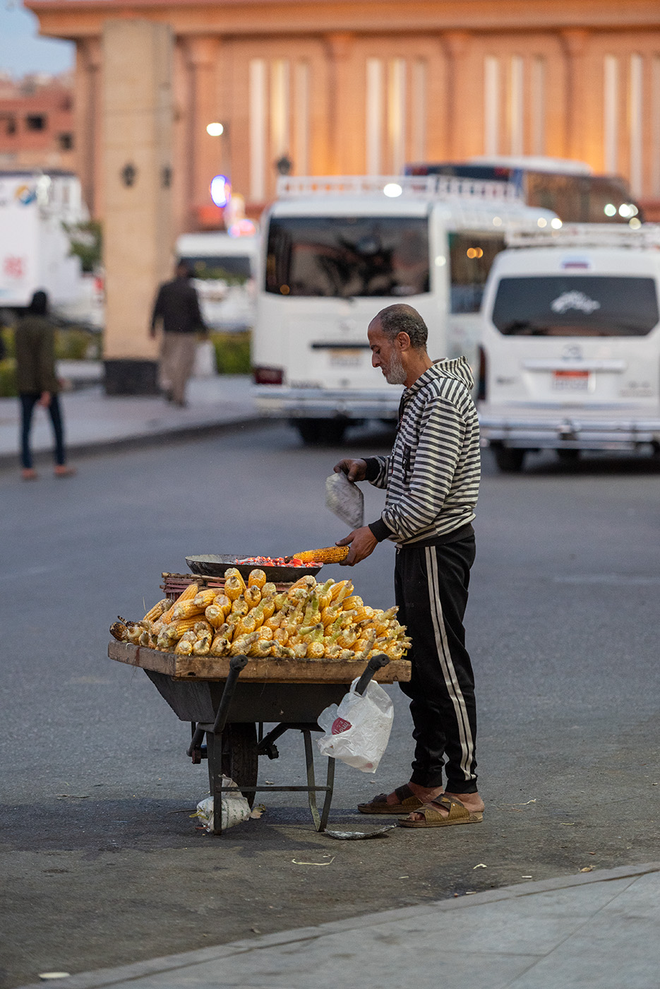 Street vendor grilling corn