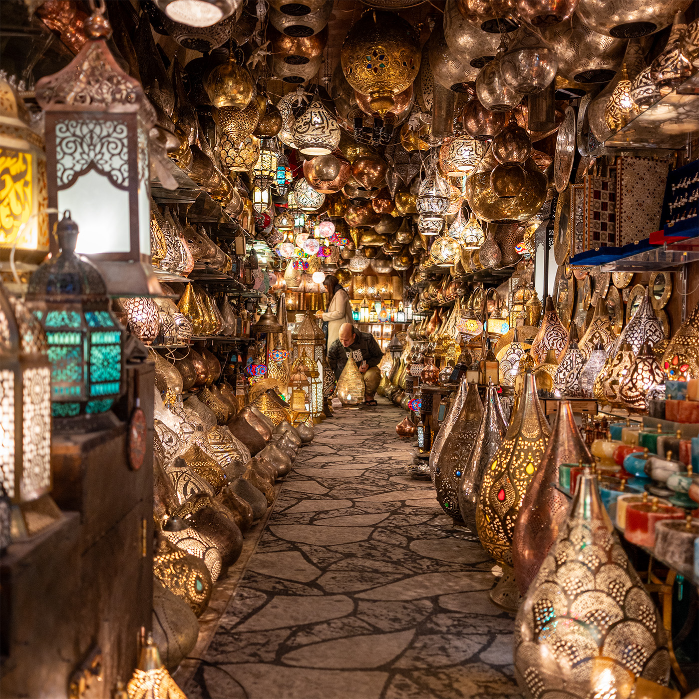 Man repairing a lamp in a well lit lamp shop