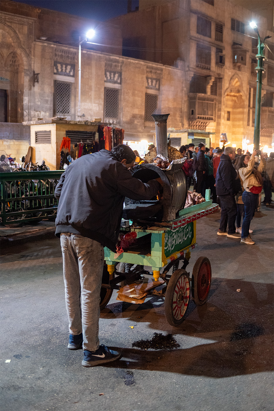 Street vendor making baked sweet potato