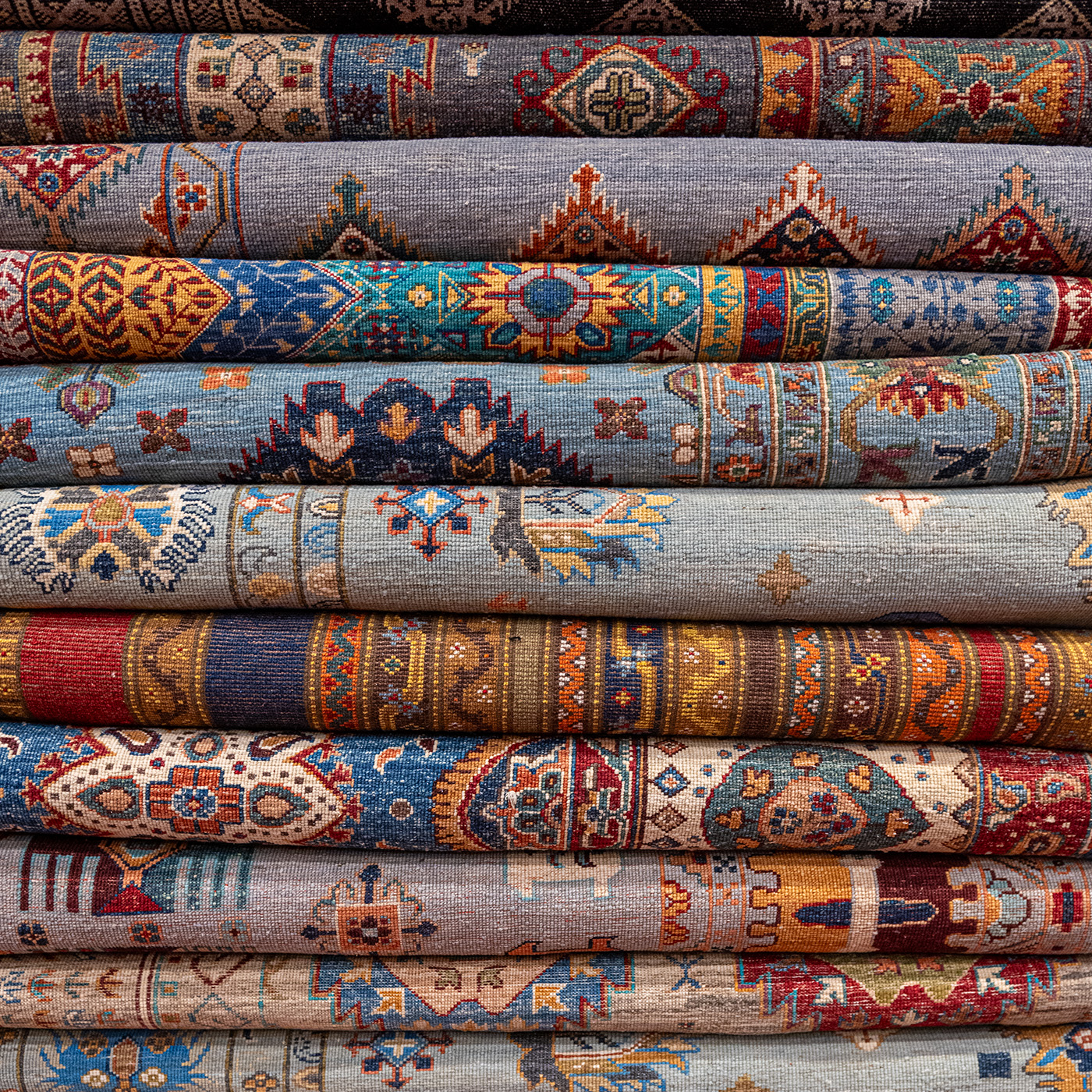 Stack of folded carpets in cool colors