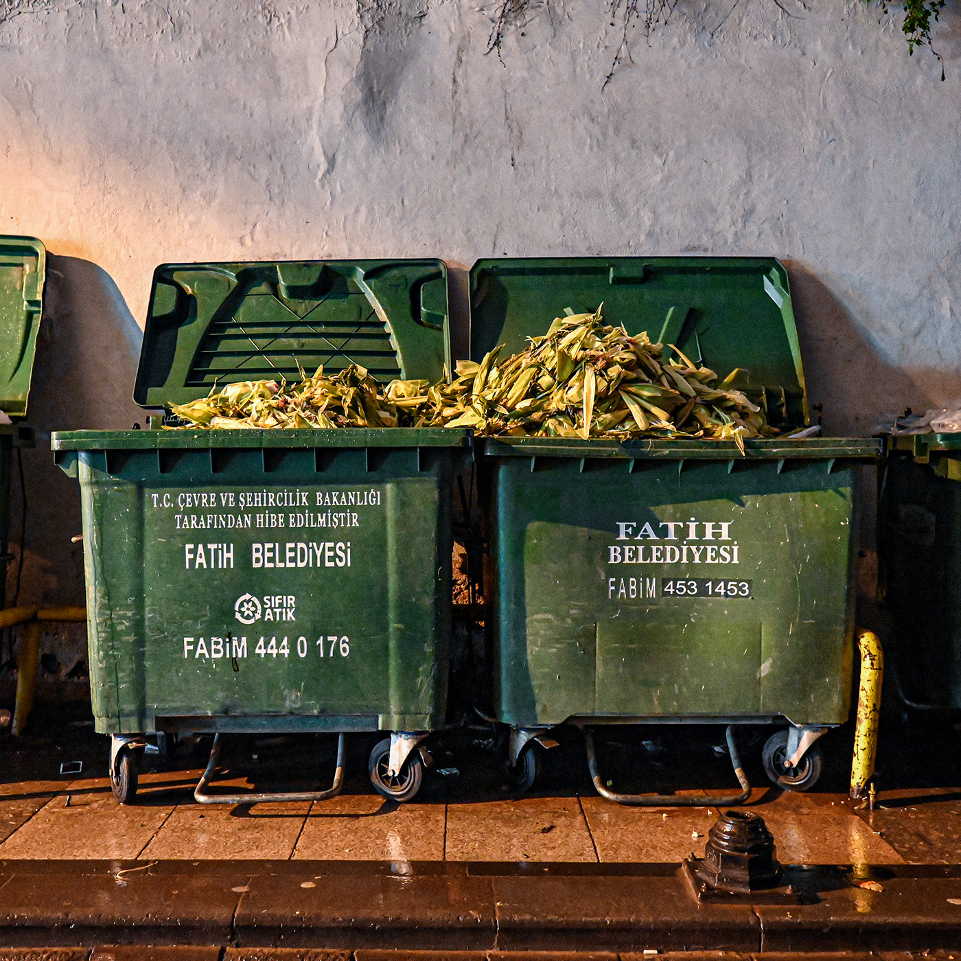 Trash bins overflowing with corn husks