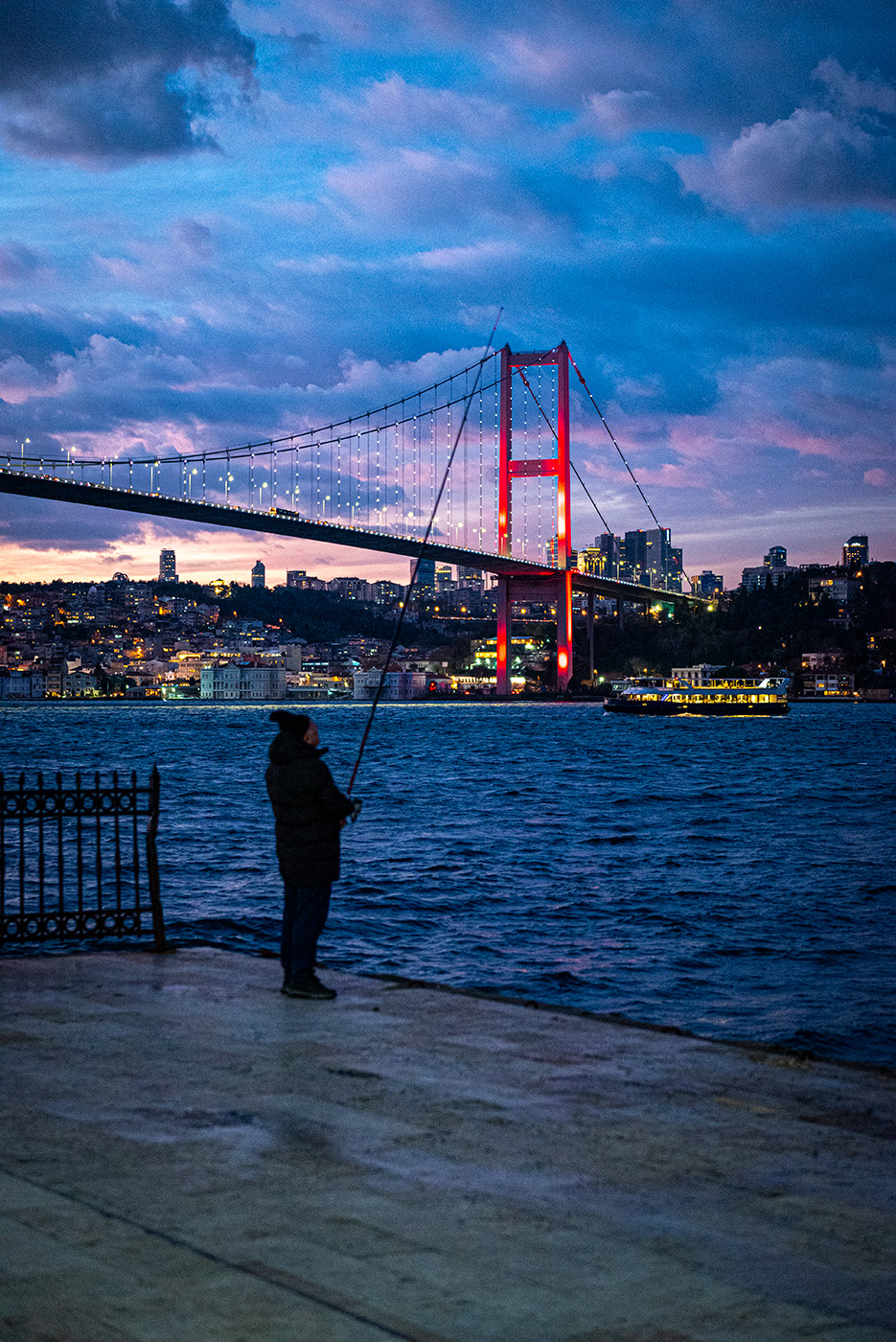 Fisherman at sunset in front of the Bosphorus Bridge