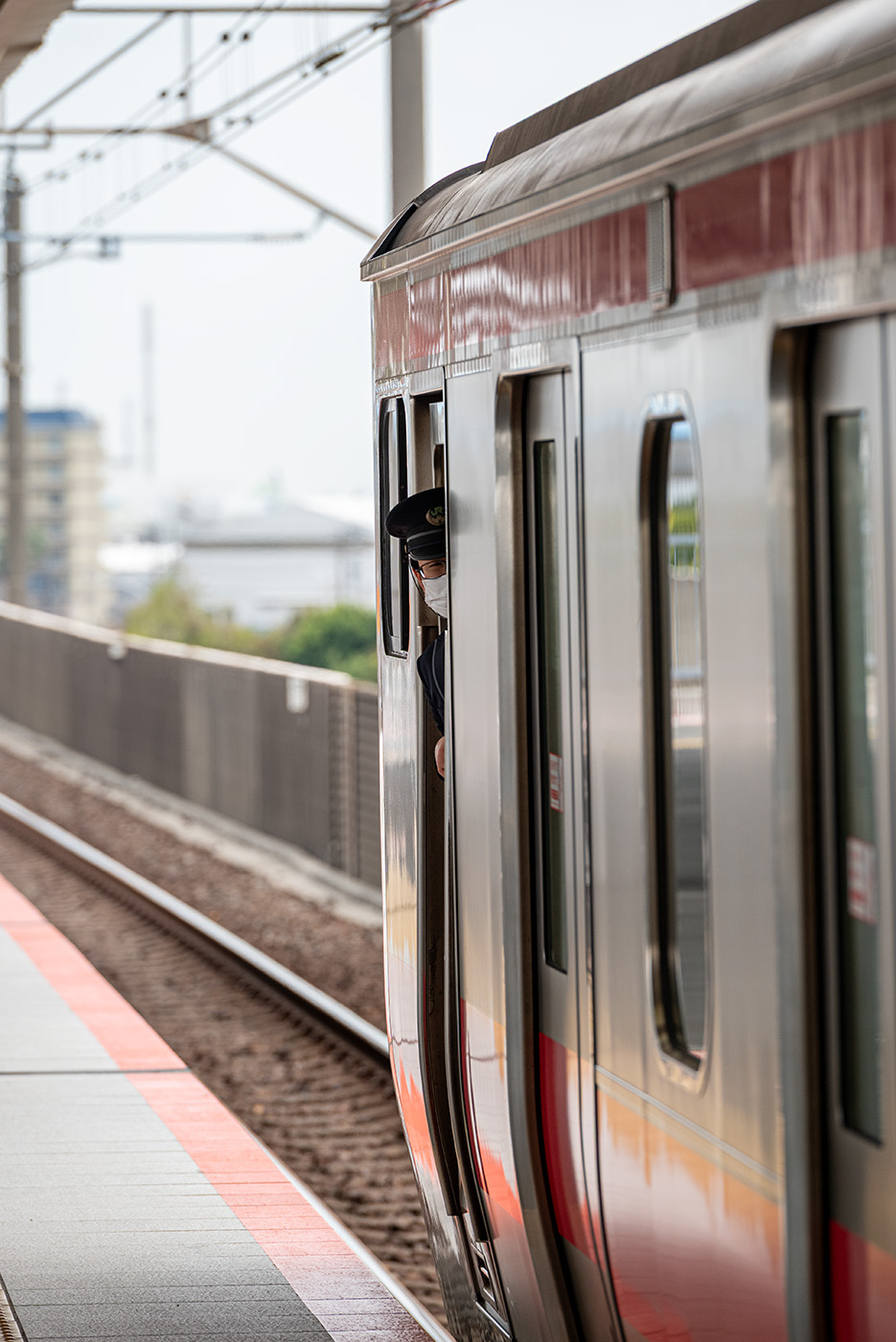 Train conductor peeking out of the train
