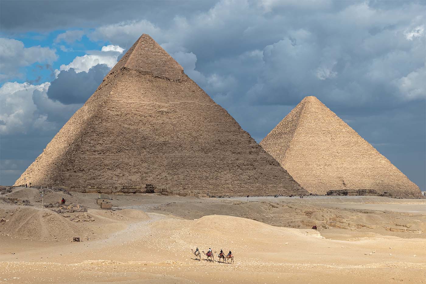 The Pyramids of Giza with a blue sky filled with clouds