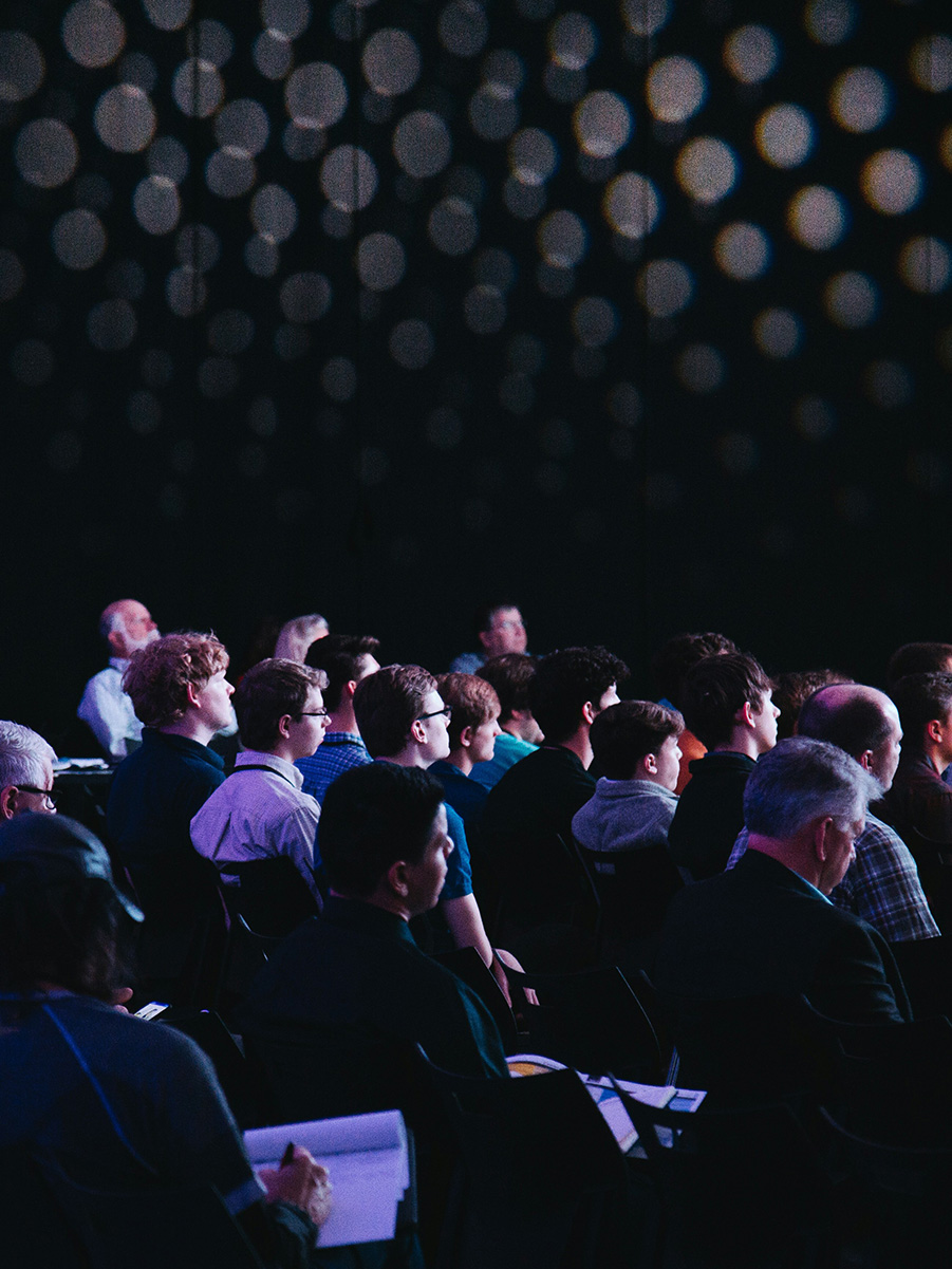 photo of audience members in a conference session